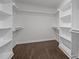 Spacious walk-in closet with hardwood floors, open shelving, and hanging rods at 333 Trout Valley Rd, Wake Forest, NC 27587
