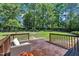 Inviting back deck with wood flooring and a seating area overlooks a spacious backyard with mature trees at 345 Kinsman Ct, Fuquay Varina, NC 27526
