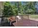Enjoy the wood back deck with space for outdoor seating and a view of the wooded backyard at 345 Kinsman Ct, Fuquay Varina, NC 27526