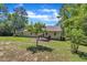 Exterior view of the home's rear showcasing the backyard, patio deck, and lush lawn at 345 Kinsman Ct, Fuquay Varina, NC 27526