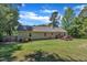 Wide backyard with a patio deck, a lush grassy area, and trees offering shade at 345 Kinsman Ct, Fuquay Varina, NC 27526