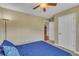 Spacious bedroom with plush carpet, a ceiling fan, and a view of the kitchen at 345 Kinsman Ct, Fuquay Varina, NC 27526