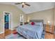 Bright bedroom features a ceiling fan, neutral walls, and hardwood flooring at 345 Kinsman Ct, Fuquay Varina, NC 27526