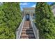 Inviting front entrance with a brick staircase and lush greenery creating a warm welcome to the home at 345 Kinsman Ct, Fuquay Varina, NC 27526