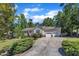 Lovely single-story house with a two-car garage and a spacious driveway surrounded by lush greenery at 345 Kinsman Ct, Fuquay Varina, NC 27526