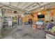 Spacious garage with ceiling fans, storage shelves, tool organizers, and concrete flooring at 345 Kinsman Ct, Fuquay Varina, NC 27526