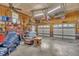 Large garage featuring three doors, organized storage shelves, work area and durable concrete flooring at 345 Kinsman Ct, Fuquay Varina, NC 27526