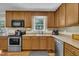 Functional kitchen with stainless steel appliances and ample cabinet storage at 345 Kinsman Ct, Fuquay Varina, NC 27526