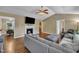 Comfortable living room with a cozy fireplace, hardwood floors, and neutral-toned walls at 345 Kinsman Ct, Fuquay Varina, NC 27526