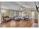 Spacious living room with hardwood floors, neutral tones, and a ceiling fan for added comfort at 345 Kinsman Ct, Fuquay Varina, NC 27526