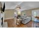 Inviting living room with hardwood floors, a fireplace, and large windows creating a cozy atmosphere at 345 Kinsman Ct, Fuquay Varina, NC 27526