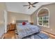 Serene main bedroom with a large window, hardwood floors, and neutral decor, creating a relaxing retreat at 345 Kinsman Ct, Fuquay Varina, NC 27526