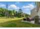 Spacious backyard with a grill, a patio set, and green grass under a clear sky, great for outdoor living at 4108 Lady Slipper Ln, Durham, NC 27704