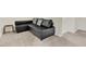 A finished basement featuring a leather L sofa and neutral carpeted floors at 4108 Lady Slipper Ln, Durham, NC 27704