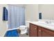 Bathroom featuring blue walls, a toilet, a sink, and a shower with a curtain creating a clean and refreshing space at 4108 Lady Slipper Ln, Durham, NC 27704