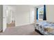 Cozy bedroom with carpet flooring, a window, and a door, creating a relaxing space at 4108 Lady Slipper Ln, Durham, NC 27704