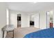 Bedroom with three open doors, a neutral carpet, and blue bedsheets at 4108 Lady Slipper Ln, Durham, NC 27704