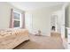 Bright and airy bedroom with a window view, closet, and door creating a comfortable retreat at 4108 Lady Slipper Ln, Durham, NC 27704