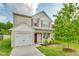 Charming two-story home with a well-manicured lawn and inviting curb appeal on a beautiful day at 4108 Lady Slipper Ln, Durham, NC 27704