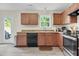 Kitchen featuring wood cabinets and stainless steel appliances and access to backyard at 4108 Lady Slipper Ln, Durham, NC 27704