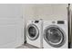 Laundry room with white appliances and tile floors, door to the side at 4108 Lady Slipper Ln, Durham, NC 27704