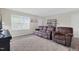 Inviting living room offers ample seating, a neutral color palette, and plenty of natural light at 4108 Lady Slipper Ln, Durham, NC 27704