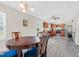 Open concept dining area, kitchen, and view to back yard with wood floors at 4108 Lady Slipper Ln, Durham, NC 27704