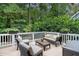 Relaxing back deck with stylish outdoor furniture and a view of the lush backyard at 429 Marsh Landing Dr, Holly Springs, NC 27540