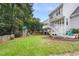 Lush backyard with a deck, a play set, a hammock, and a well-manicured lawn at 429 Marsh Landing Dr, Holly Springs, NC 27540