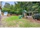 Large backyard with a ' play set and plenty of room for outdoor activities at 429 Marsh Landing Dr, Holly Springs, NC 27540