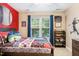 A bright bedroom with baseball-themed decor and large windows for natural light at 429 Marsh Landing Dr, Holly Springs, NC 27540