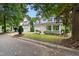 Two-story home with a two car garage, blue shutters, front porch, and manicured landscaping on a treed lot at 429 Marsh Landing Dr, Holly Springs, NC 27540