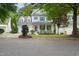 Two-story home with a two car garage, blue shutters, front porch, and manicured landscaping at 429 Marsh Landing Dr, Holly Springs, NC 27540