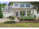 Charming two-story home features a welcoming front porch with blue shutters and manicured landscaping at 429 Marsh Landing Dr, Holly Springs, NC 27540