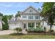 Charming two-story home features a welcoming front porch with blue shutters and manicured landscaping at 429 Marsh Landing Dr, Holly Springs, NC 27540