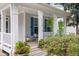 Inviting front porch with ample seating, bright blue shutters, and decorative plants creates a cozy outdoor space at 429 Marsh Landing Dr, Holly Springs, NC 27540