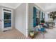 Inviting covered front porch with seating, bright blue shutters, and a blue front door create a cozy outdoor space at 429 Marsh Landing Dr, Holly Springs, NC 27540