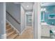 Inviting hallway featuring stairs and a bathroom with blue accent wall at 429 Marsh Landing Dr, Holly Springs, NC 27540