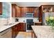 Well-equipped kitchen with stainless steel appliances, granite countertops, and ample cabinet space at 429 Marsh Landing Dr, Holly Springs, NC 27540