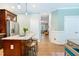 Open-concept kitchen with a center island, seating, and seamless flow into the living area and hallway at 429 Marsh Landing Dr, Holly Springs, NC 27540