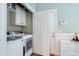 Functional laundry room equipped with modern appliances and ample storage solutions at 429 Marsh Landing Dr, Holly Springs, NC 27540