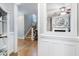 Open doorway reveals a carpeted staircase and a light-filled living room with a fireplace and ceiling fan at 429 Marsh Landing Dr, Holly Springs, NC 27540