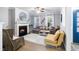 Inviting living room featuring a fireplace, wood floors, comfortable seating, and natural light from the windows at 429 Marsh Landing Dr, Holly Springs, NC 27540