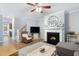 Cozy living room features a fireplace with a decorative mantel, comfortable seating, and ample natural light at 429 Marsh Landing Dr, Holly Springs, NC 27540