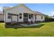 A well manicured backyard with a porch, patio, swing, and lush lawn at 45 Hawley Ridge Dr, Dunn, NC 28334