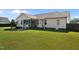 View of backyard showcasing the home's exterior, swing, patio, and lush lawn at 45 Hawley Ridge Dr, Dunn, NC 28334
