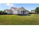 A spacious backyard with well-maintained lawn and an exterior of the home at 45 Hawley Ridge Dr, Dunn, NC 28334