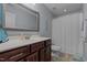 Bathroom featuring a vanity with a large mirror, tile floor, and a shower with a shower curtain at 45 Hawley Ridge Dr, Dunn, NC 28334