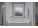 Bathroom showing large tub, window, and wall mounted shower head at 45 Hawley Ridge Dr, Dunn, NC 28334