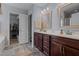 Bathroom features a double sink vanity, mirrors, and access to the walk-in closet at 45 Hawley Ridge Dr, Dunn, NC 28334